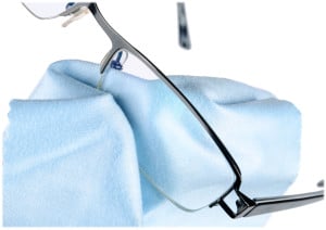 Eyeglasses being cleaned with microfiber cloth